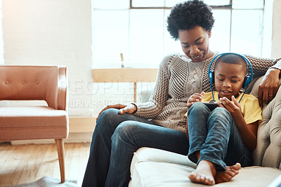 Buy stock photo Tablet, relax and black family of child, mother or African people relax together, bonding and enjoy quality time. Love, digital tech and youth kid listening to music, streaming video or online gaming