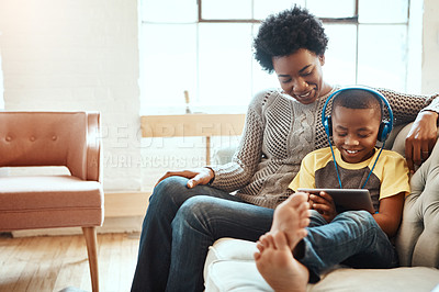 Buy stock photo Shot of a mother and son using a tablet indoors
