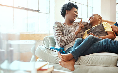 Buy stock photo Black family, son and mother relax on a sofa, laugh and happy while bond in their home together. Mom, love and boy resting with parent, content and playful while sitting and talking in living room