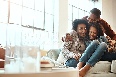 Buy stock photo Love, bond and family hugging while relaxing together in the living room of their modern house. Happy, smile and African parents spending quality time, talking and hugging girl child on sofa at home.