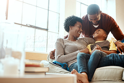 Buy stock photo Black family, happy and relax on sofa with boy and parents, hug and laughing in their home together. Happy family, mother and father playing with their son on a couch, content and joy in living room