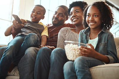 Buy stock photo Black family watching tv on sofa for movie, film and cartoon together, bonding and quality time in living room. Popcorn, kids television show of people, mother and father with kids, on couch watching