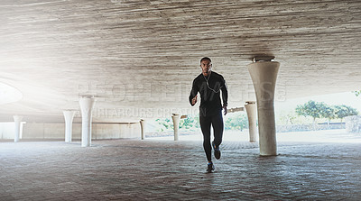 Buy stock photo Man, face and running for fitness outdoor with music, listening to podcast and exercise for healthy body. Athlete, person and earphones with audio, radio and sound for marathon training in car park