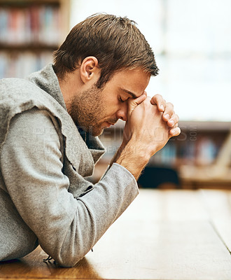 Buy stock photo Student, praying and spiritual in university for study, worship and college scholarship in library. Man, faith and meditation to God on campus for school project, education and final exam or test