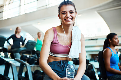 Buy stock photo Cropped portrait of an attractive young woman taking a break from her workout in the gym