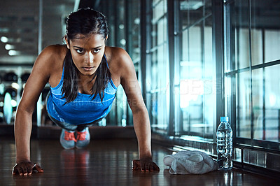 Buy stock photo Serious, push up and woman in gym for workout with strength, wellness and arms training. Fitness, health and female athlete with exercise, challenge with strong muscle and power in sports center.