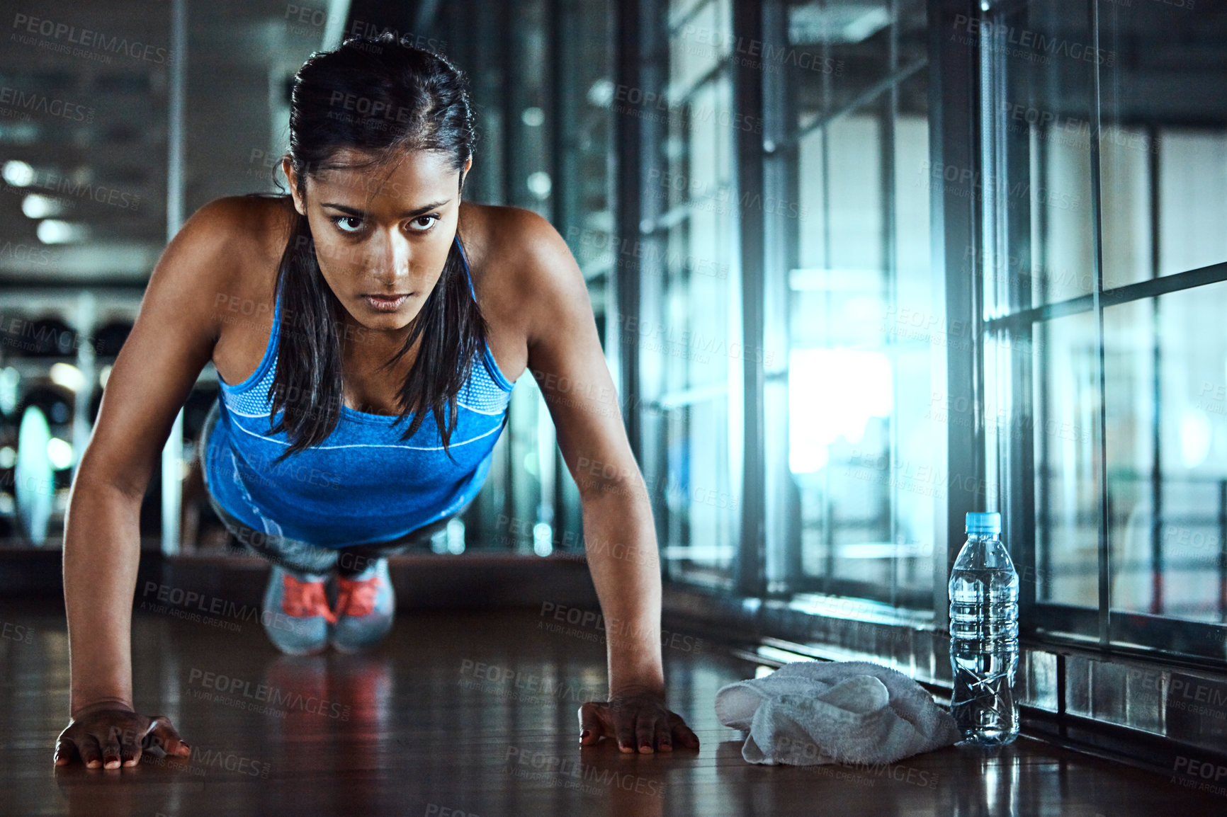 Buy stock photo Serious, push up and woman in gym for workout with strength, wellness and arms training. Fitness, health and female athlete with exercise, challenge with strong muscle and power in sports center.