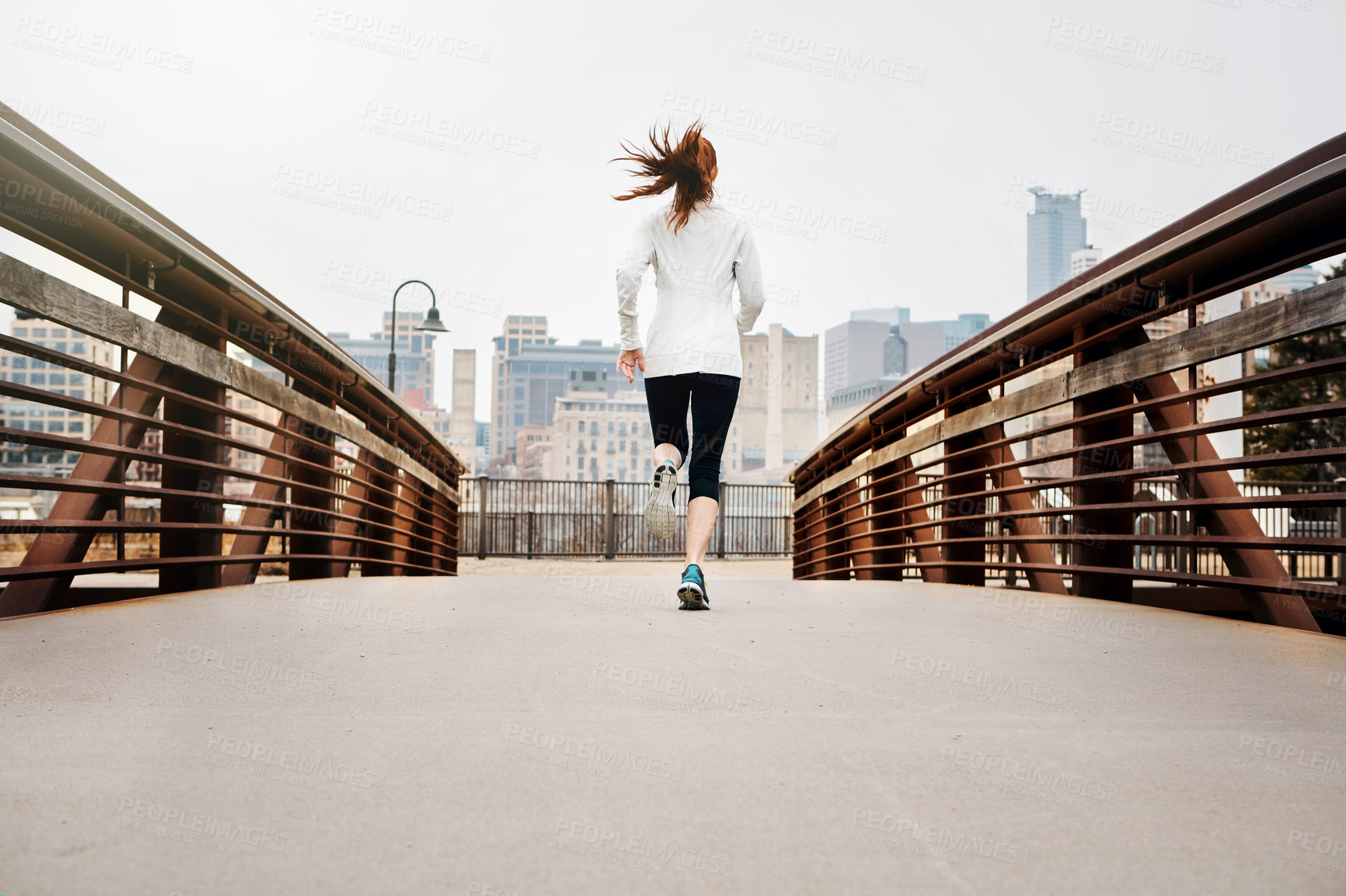 Buy stock photo Back, girl and running by bridge in city, endurance and speed with fitness exercise Germany. Training, female runner and preparation for marathon, challenge and healthy living with workout outdoor