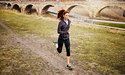 Buy stock photo Speed, woman and running by bridge in nature, endurance and race with fitness in Germany. Training, female runner and preparation for marathon, challenge and healthy living with workout outdoor