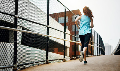 Buy stock photo Back, girl and running by city on road, endurance and speed with fitness exercise in Germany. Training, female runner and preparation for marathon, challenge and healthy living with workout outdoor