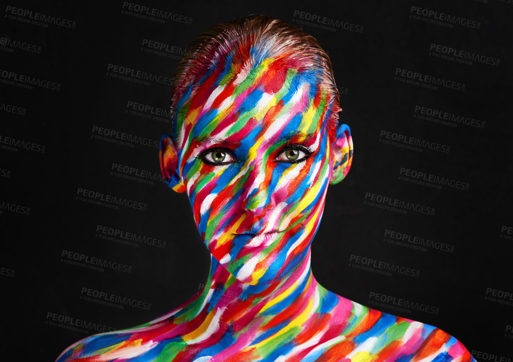 Buy stock photo Studio shot of a young woman posing with brightly colored paint on her face against a black background