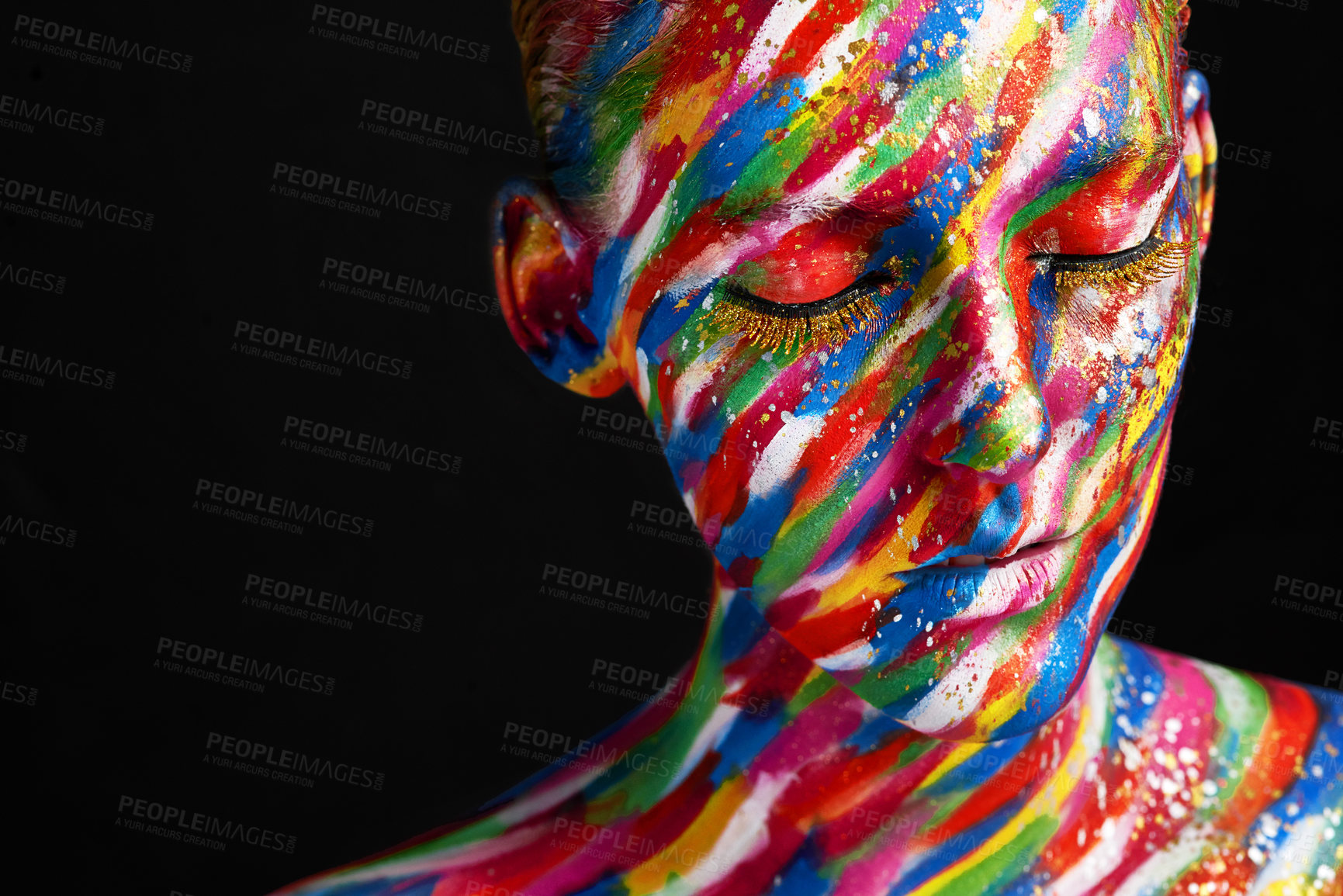 Buy stock photo Studio shot of a young woman posing with brightly colored paint on her face against a black background