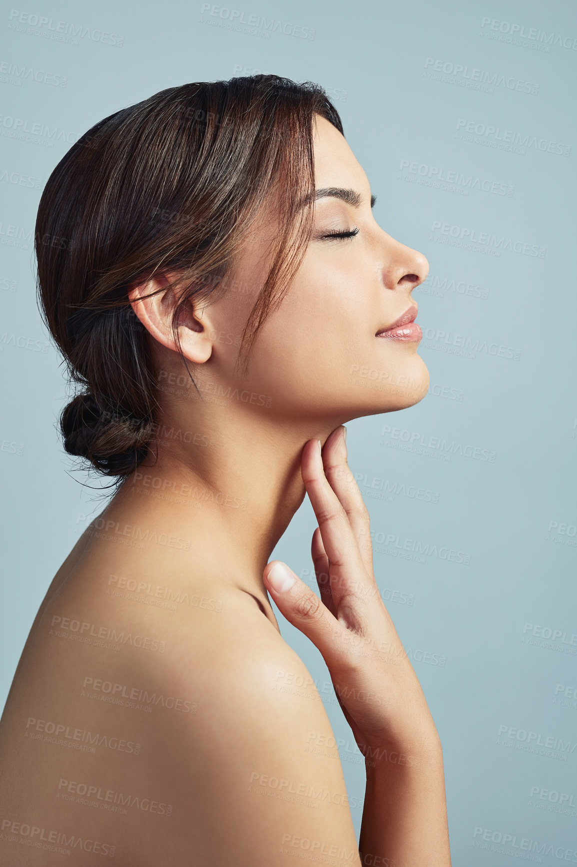 Buy stock photo Profile, beauty and skincare of woman with eyes closed for glow, aesthetic or dermatology. Face, touch and model in natural makeup for cosmetics treatment, shine and results on blue studio background