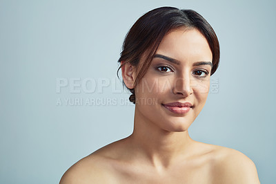 Buy stock photo Portrait, glow and skincare of woman with beauty, clean and aesthetic isolated on blue studio background. Face, makeup and confident model with cosmetics for shine, dermatology and treatment results