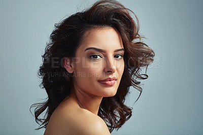 Buy stock photo Woman, portrait and curly hairstyle in studio, texture and conditioner for volume on blue background. Female person, confident hair care and dermatology for grooming, pride and cosmetics in India