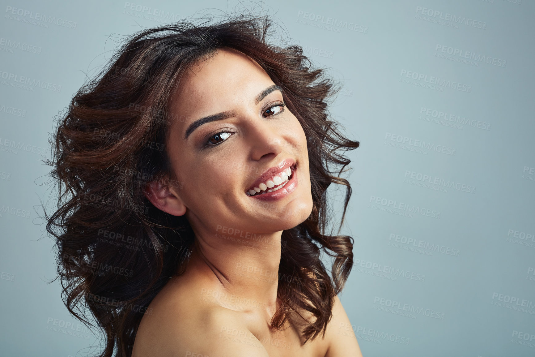 Buy stock photo Woman portrait, growth and curly hairstyle in studio, texture and conditioner for volume on blue background. Female person, hair care and dermatology for grooming, mockup and cosmetics in India