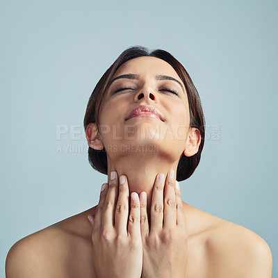 Buy stock photo Eyes closed, hands and skincare of woman with beauty, cosmetics or aesthetic. Touch neck, makeup and model in treatment for healthy skin, dermatology and hydration results on blue studio background