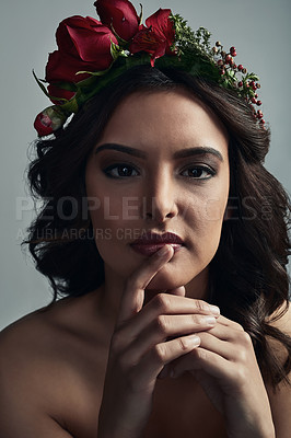 Buy stock photo Studio shot of a beautiful young woman wearing a floral head wreath against a grey background