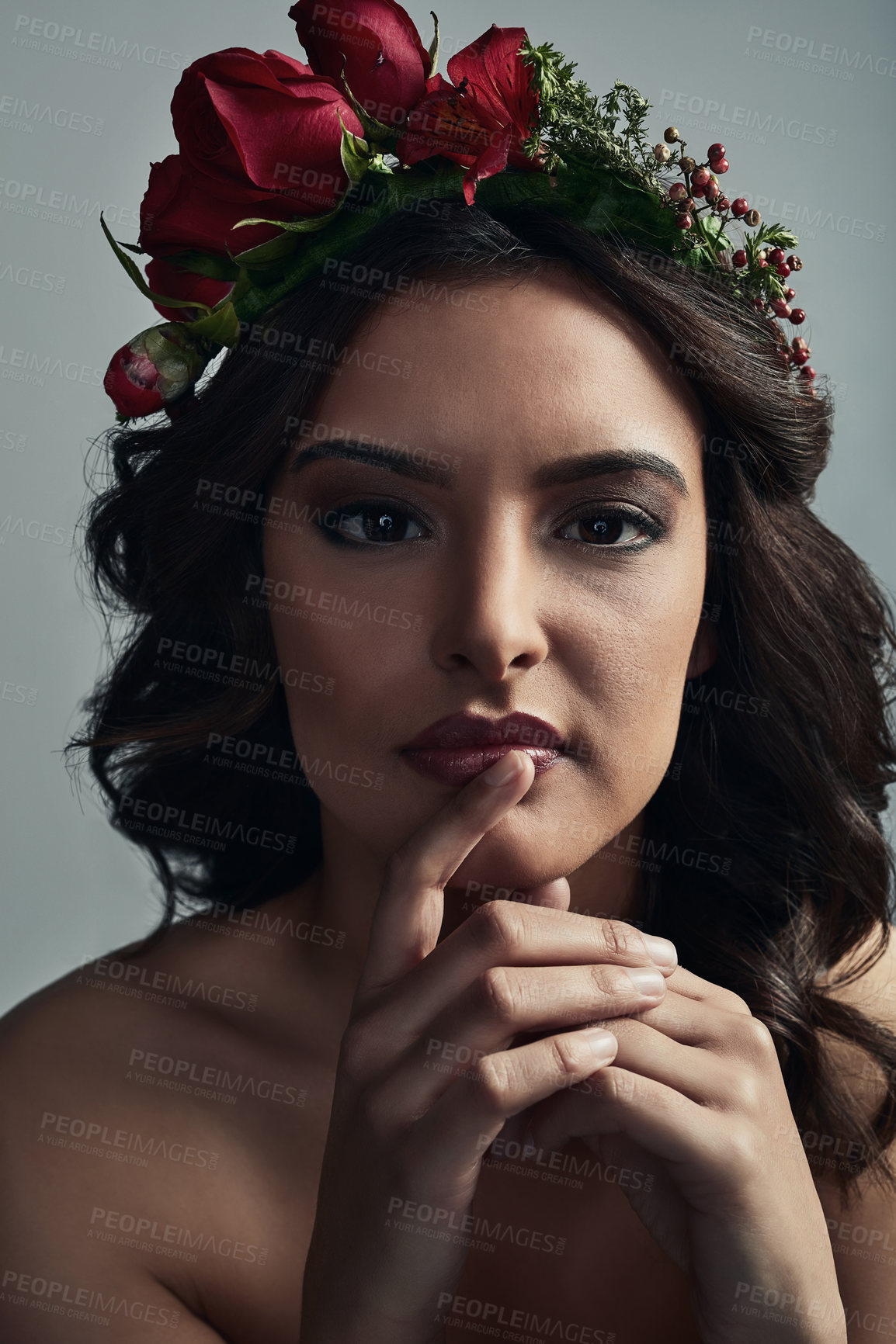 Buy stock photo Studio shot of a beautiful young woman wearing a floral head wreath against a grey background