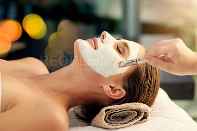 Buy stock photo Shot of a beautiful young woman lying on a massage table at the day spa