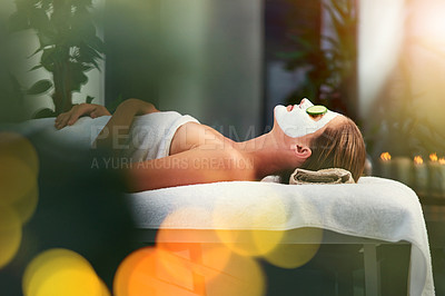Buy stock photo Shot of a beautiful young woman lying on a massage table at the day spa