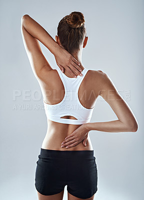 Buy stock photo Woman, neck and back pain with fitness injury, strain or muscle inflammation on a white studio background. Rear view of female person with sore spine from overworked exercise, training or workout