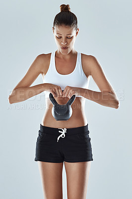 Buy stock photo Slim, woman and kettlebell in workout for fitness, exercise and wellness with weight in studio background. Young, female person and sportswear in backdrop for muscle, body and strength as athlete