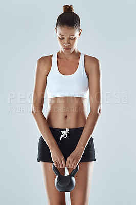 Buy stock photo Slim, woman and kettlebell in fitness for workout, exercise and wellness with weight in studio background. Young, female person and sportswear in backdrop for muscle, body and strength as athlete