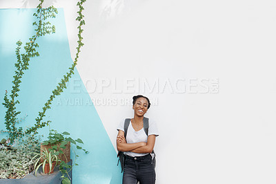 Buy stock photo Shot of a cheerful young student standing outside smiling while looking at the camera
