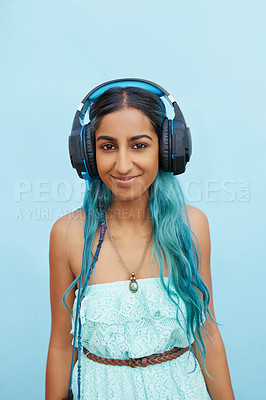 Buy stock photo Woman, headphones and portrait with music, smile and blue wall background on campus. Student, happiness and podcast audio or radio for education, college and confidence with university break or rest