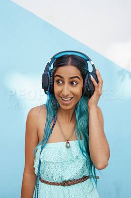 Buy stock photo Woman, headphones and excited with music, smile and happiness with blue wall background on campus. Girl, listening and podcast audio or radio for sound track, streaming subscription and online media
