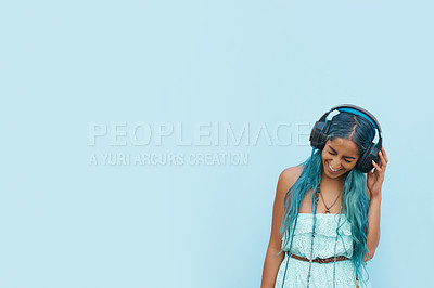 Buy stock photo Woman, headphones and laugh with music, mockup space and blue wall background on campus. Student, positivity and podcast audio or radio for education, college and confidence for university break