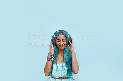 Buy stock photo Shot of a cheerful young student listening to music on headphones outside with her eyes closed