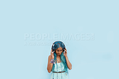 Buy stock photo Woman, headphones and satisfaction with music, mockup space and blue wall background on campus. Student, listen and podcast audio or radio for education, college and confidence with university break