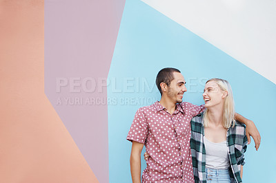 Buy stock photo Couple, young and  gen z, happy in studio and hug for bonding with laughter together and casual fashion on color block background. Mockup space, colorful wall and people in relationship with style