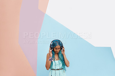 Buy stock photo Woman, headphones and colours with music, mockup space and blue wall background on campus. Student, listen and podcast audio or radio for education, college and confidence for university break