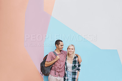 Buy stock photo Couple, students and embrace for love, bonding together and hug on university campus. Color block, happiness and young woman with man on college ground for knowledge, higher education or scholarship