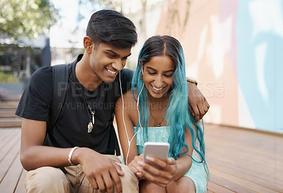 Buy stock photo Couple, earphones and student with mobile phone for social media, meme or watching video on campus. Headphones, happy man and woman with smartphone for internet search, online app or web browsing