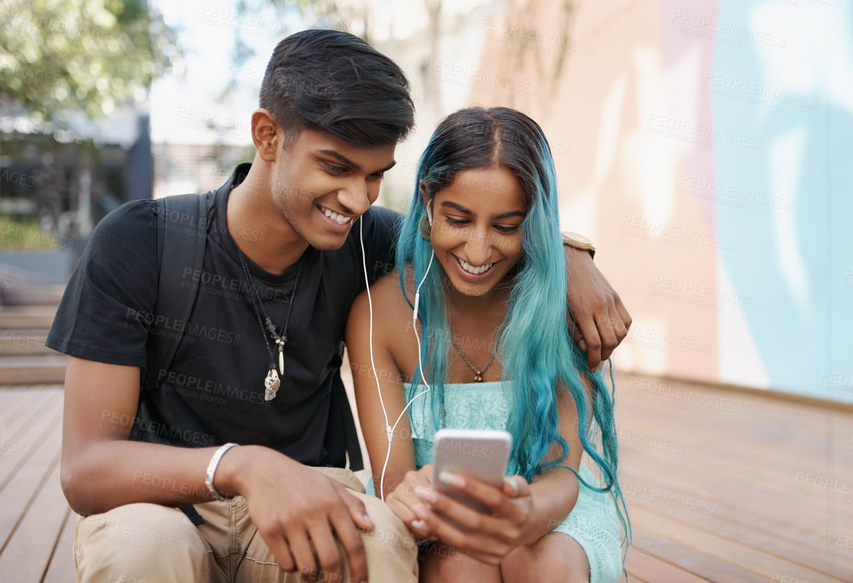 Buy stock photo Couple, earphones and student with mobile phone for social media, meme or watching video on campus. Headphones, happy man and woman with smartphone for internet search, online app or web browsing