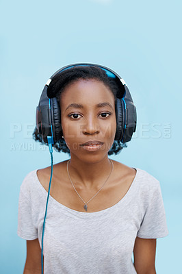 Buy stock photo Headphones, audio and portrait of girl in studio for audio streaming, radio or online podcast. Black person, student and relax with technology for media, sound and connection on blue background