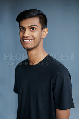 Buy stock photo Studio portrait of a handsome young man standing against a blue background