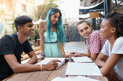 Buy stock photo Friends, group and learning outdoor at university with books, listening and study for education on campus. Students, gen z people or teamwork research with smile, diversity and college break by table