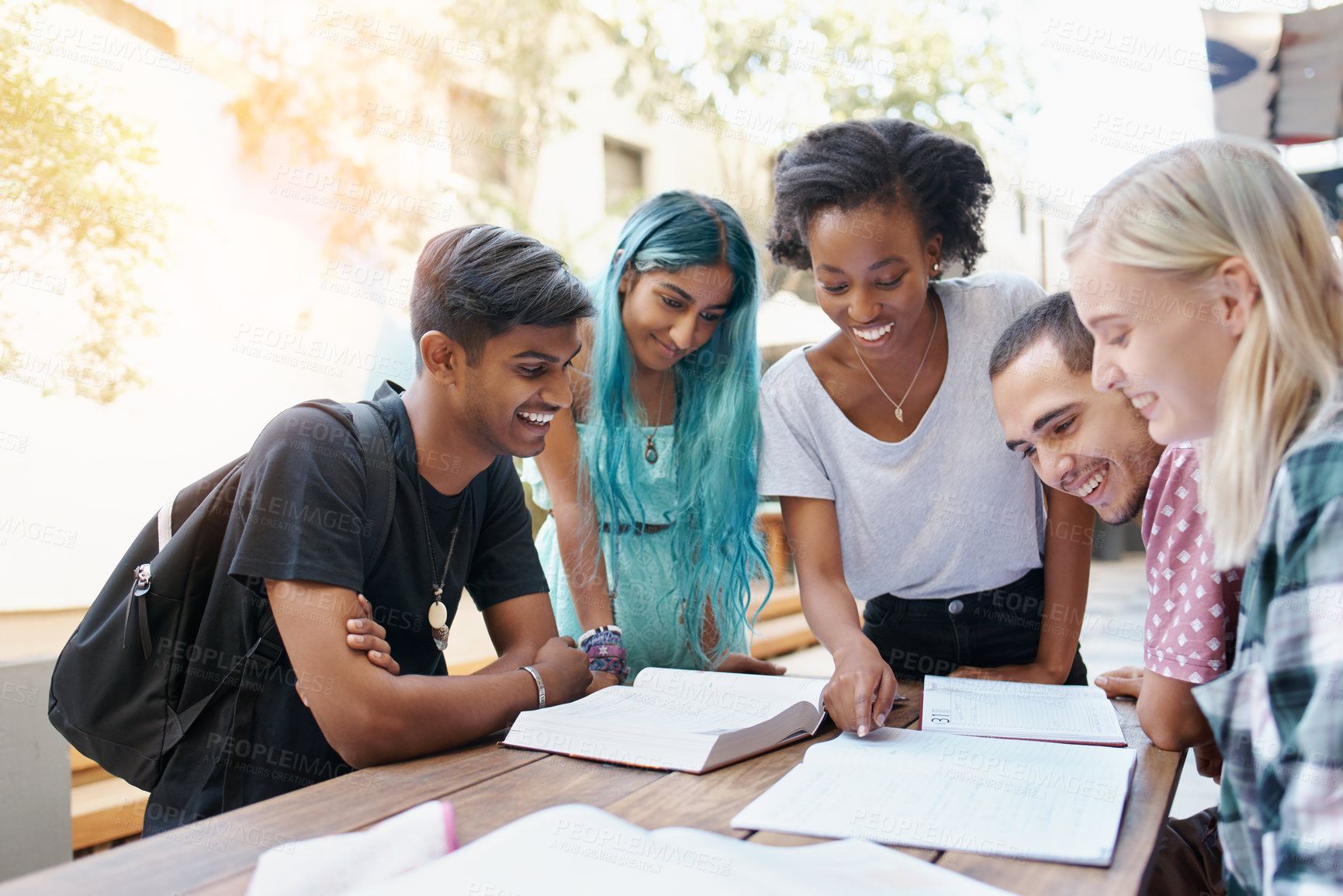 Buy stock photo Friends, group and study outdoor at university with books, pointing and learning for education and campus. Students, gen z people and teamwork research with diversity, happy or college break by table