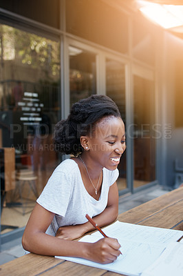 Buy stock photo Shot of a young female student enjoying a break outdoors on campus