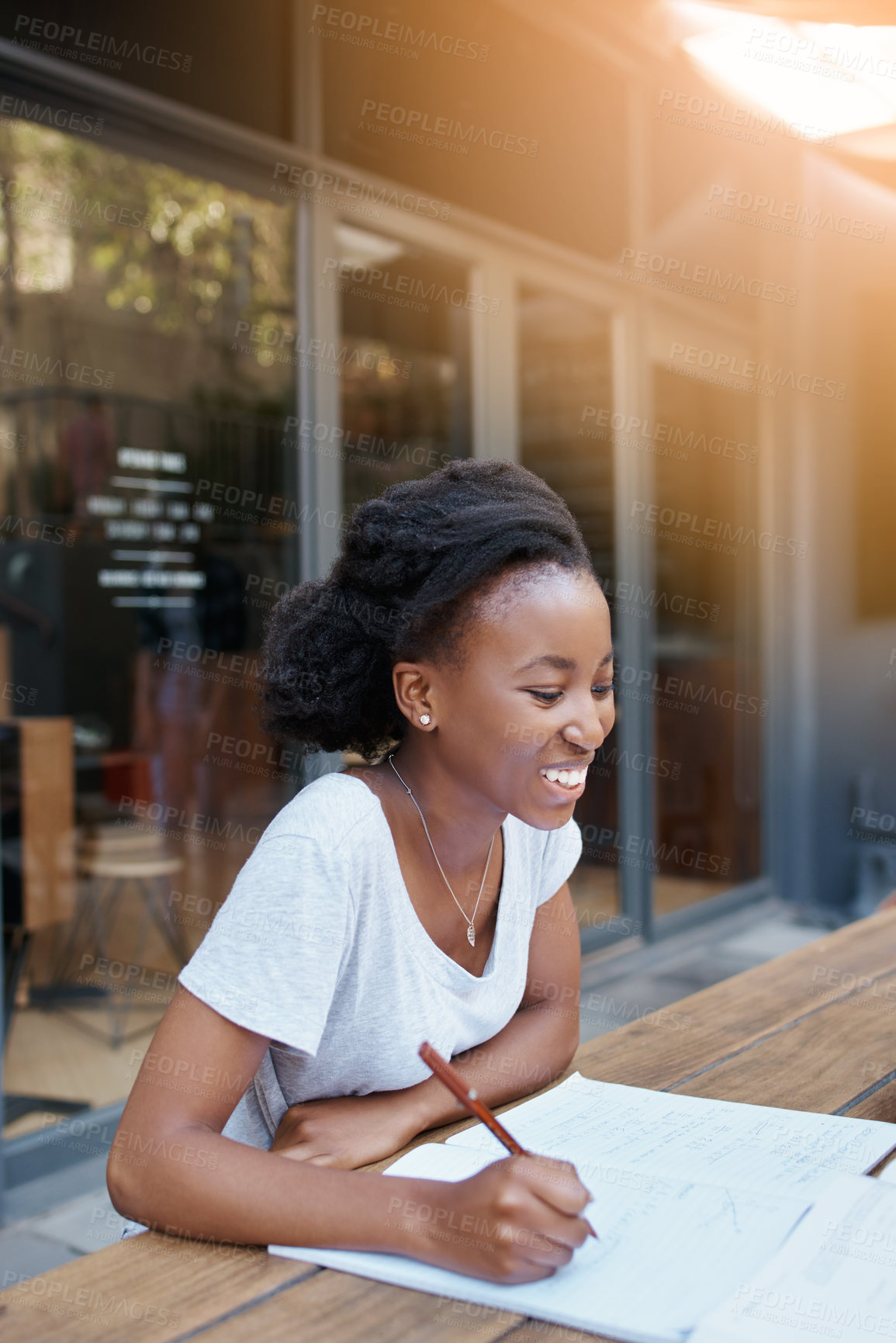 Buy stock photo Shot of a young female student enjoying a break outdoors on campus