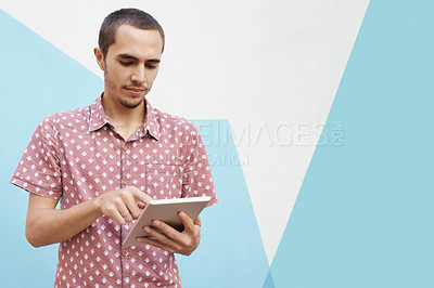 Buy stock photo Tablet, search and man in studio for college newsletter, sign up or elearning registration on blue background. Digital, app or gen z student online for ebook streaming, research or upskill education