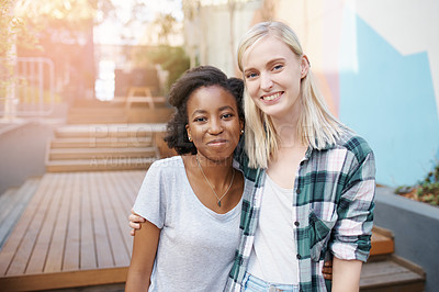 Buy stock photo Shot of two happy young friends spending time together outside