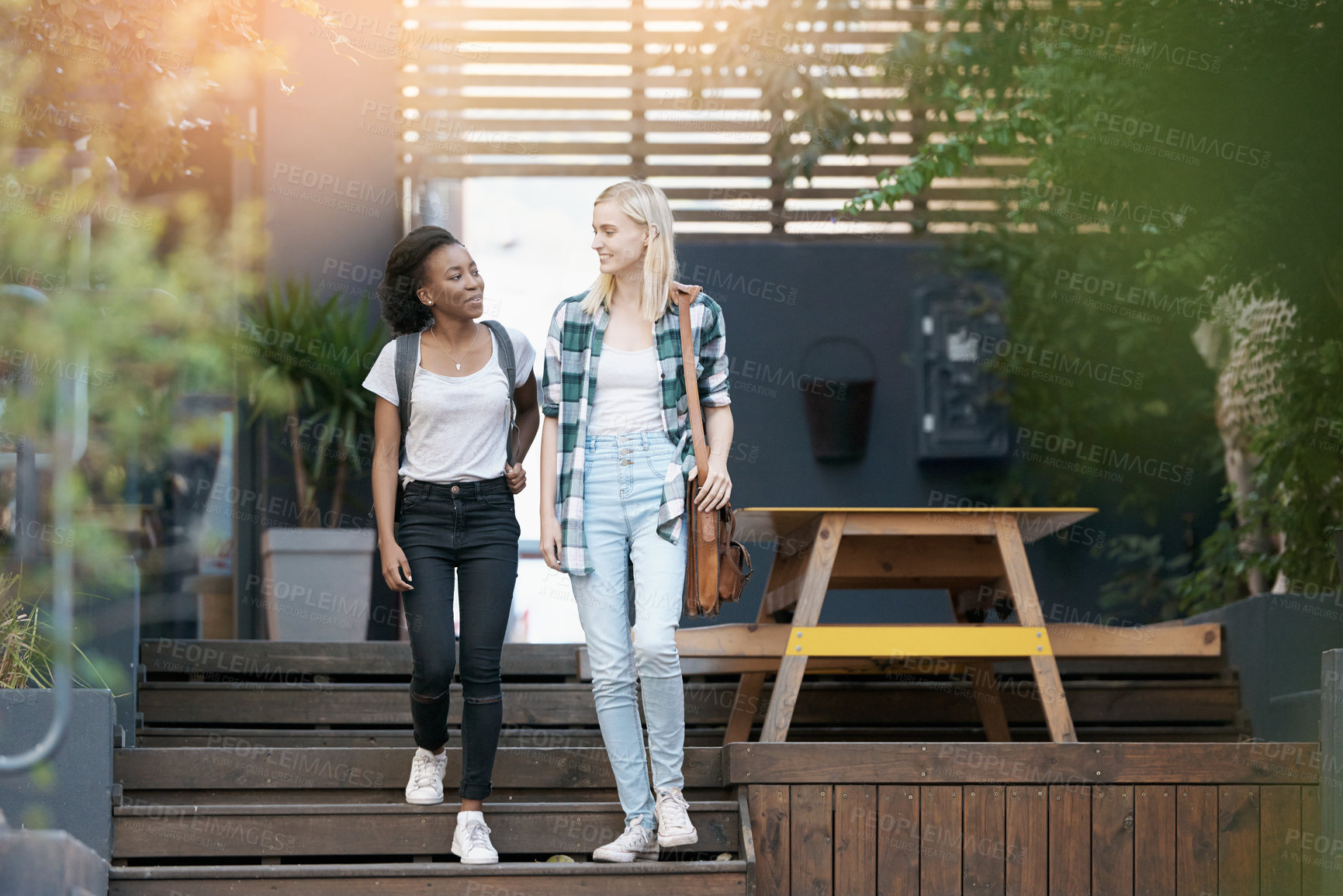 Buy stock photo Walking, conversation and girl students at university planning for study, assignment or test. Networking, discussion and young women with bags bonding and talking by stairs at college campus together