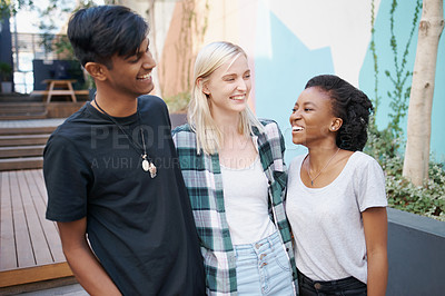 Buy stock photo Shot of a group of happy young friends spending time together outside