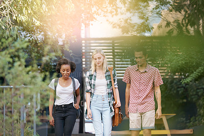 Buy stock photo Walking, conversation and young students at university planning for study, assignment or test. Networking, discussion and diversity friends with bags bonding and talking at college campus together.